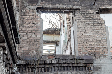 Fototapeta na wymiar Ruined old house. And the blue sky. The remains of old houses. Abandoned city. The city of ghosts. The ruins of old historic buildings destroyed by an earthquake.