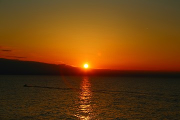 Amber sky at sunset over the water
