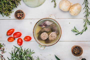 liverwurst in broth. soup with a pot.