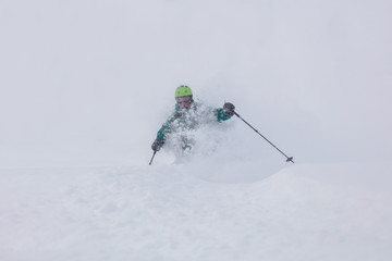 Freerider is buried in fresh snow, turning and jumping between the trees. freeride skiing in deep...