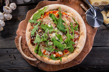 Homemade pizza with arugula, nuts and cheese