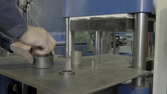 Worker works with press in the workplace
