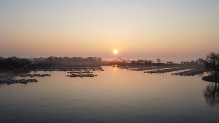 Gorgeous wide angle shot of empty boat docks with early morning sunrise and fog in Chicago Illinois