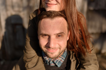 Obraz premium Young fashion couple posing on the street in sunny fall . Creamy autumn sunlight.