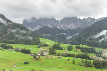 Fototapeta na wymiar Small Italian mountain town in the Dolomites ( St. Magdalena in Val di Funes )
