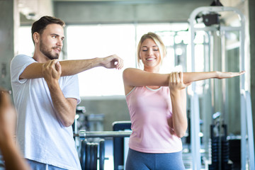 Fototapeta na wymiar Sport couple stretching muscle before sport activity in fitness gym club