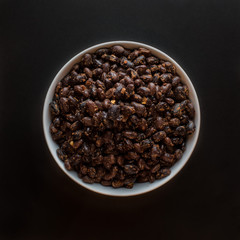 beans in bowl on black background