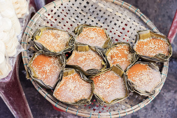 Asian street market selling sweet mango cake in Vietnam
