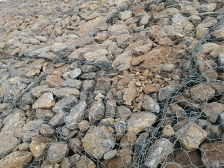 Limestone in wire mesh for construction.