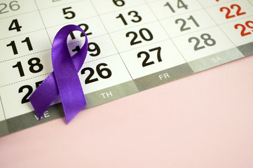 March 26 is World Epilepsy Day. A close-up date is marked on the calendar with a purple ribbon. Copy space for text.