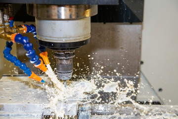 The CNC milling machine rough cutting the mold and die parts with liquid coolant method. The mold...