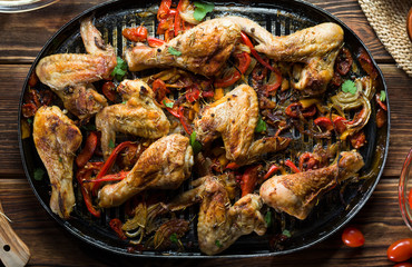 Roasted chicken leg with vegetables and spices.