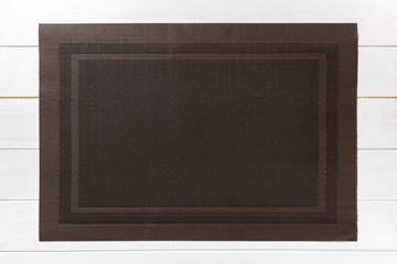 Top view of empty brown table napkin for dinner on wooden background with copy space