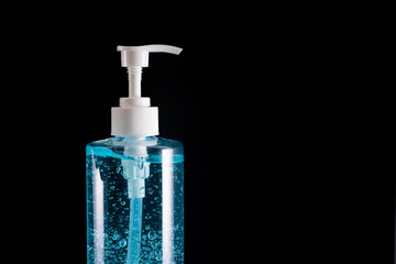 Blue hand sanitizer gel in clear pump bottle with black background, that use for killing germs, bacteria and viruses. Prevent the spread of germs and bacteria and avoid infections corona virus.