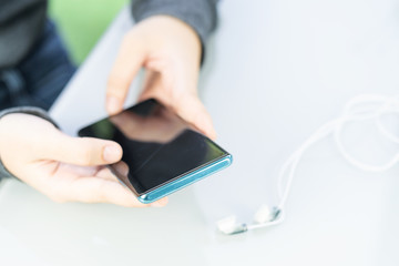 Woman sitting and using smartphone for online shopping with credit card  on deck in home office