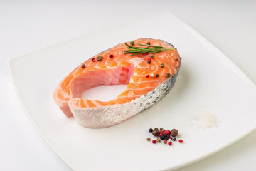 Fresh raw salmon steak isolated on white background.