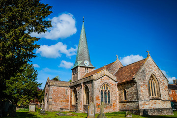 Fototapeta na wymiar Old English church with graveyard