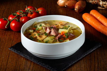 Soup with smoked meat, vegetables and pasta