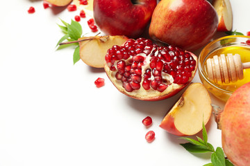 Apple, honey and pomegranate on white background, close up