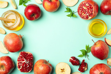 Apple, honey and pomegranate on mint background, space for text