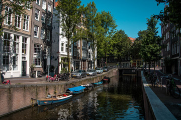 Fototapeta na wymiar Cityscape of Amsterdam, Netherlands. Parking near the canal. Dutch urban architecture. Tourism in Europe.