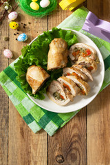 Festive appetizer. Chicken meatloaf with dried apricots, mozzarella and herbs on a festive Easter table. Top view flat lay background. Copy space.