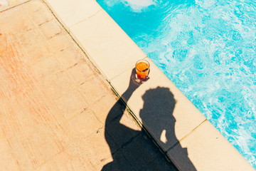 orange cocktail at the pool