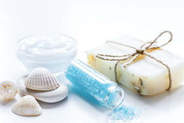 blue set for bath with salt and shells on white table background