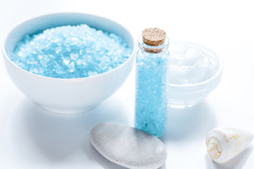 Obraz na płótnie Canvas spa composition with blue sea salt and natural soap on white desk background