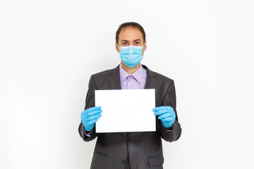 Close up of a businessman in a suit wearing Protective face mask, get ready for Coronavirus and pm 2.5 fighting against gray background. Healthcare concept.