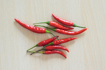 Red hot chili on the wood table.