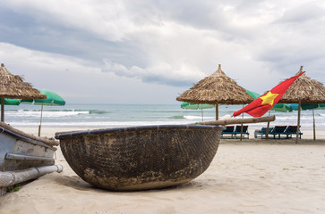 Flag and Bamboo boat on China Beach in Danang Vietnam