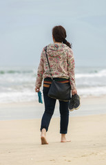 Young girl passing by in China Beach in Danang
