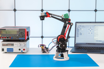 Model of a robot and a laptop on a table in a design office
