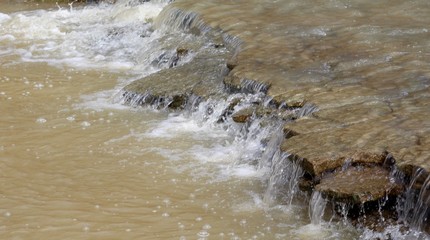 A close view of the flowing water of the brook.