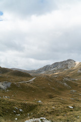 Scenic view of the mountains. Mountain road meanders between the hills. Background