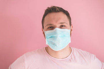 A man in a viral mask on a pink background, wearing face protection in prevention for coronavirus