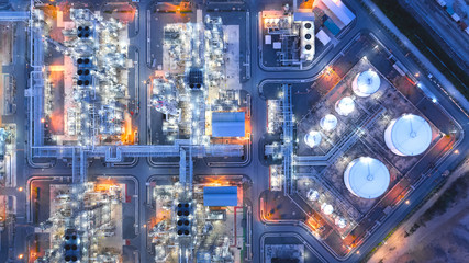 Large industrial estates of oil and gas refinery, Aerial view of industry plants, oil storage tanks and pipeline at night.