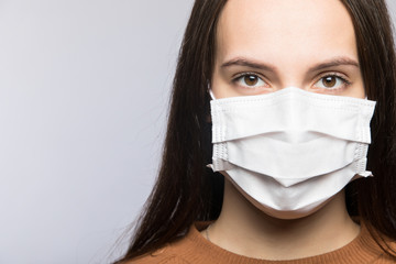 Stop coronavirus infection. The girl in the mask.