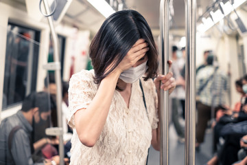 Asian woman wearing mask for prevent dusk pm 2.5 bad air pollution and coronavirus or covid-19...
