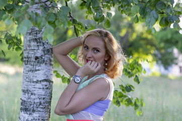Portrait of a girl with a blade of grass in her mouth.