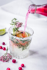 fresh homemade drink with berries and lime on kitchen background