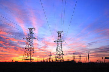In the evening, the high voltage tower and the beautiful sunset glow