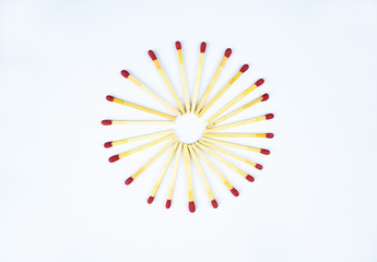 Circle made with some flammable red fire matches with writable space on white paper