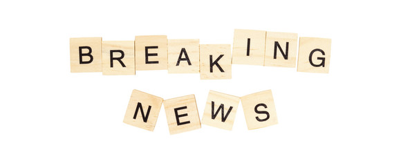 The words "Breaking News" spelt out with letter tiles on the white background