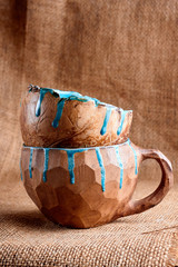 Beautiful closeup of unique handmade two empty clay cups on rustic burlap background
