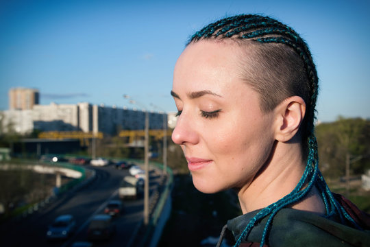 A woman wearing synthetic cornrows