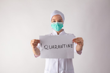 Girl doctor holds a quarantine sign in his hands