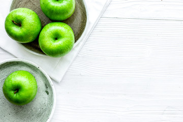 Healthy green food with apples on plates white background top view mock up