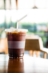 Iced americano coffee mix with orange juice and slice orange